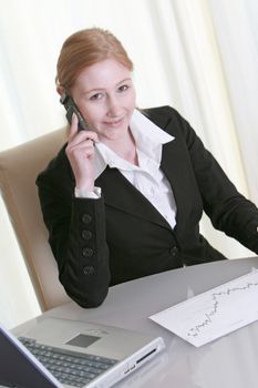 a business woman on the phone and smiling
