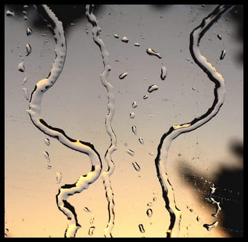 rain streams and morning dew backgrounded by sunrise light