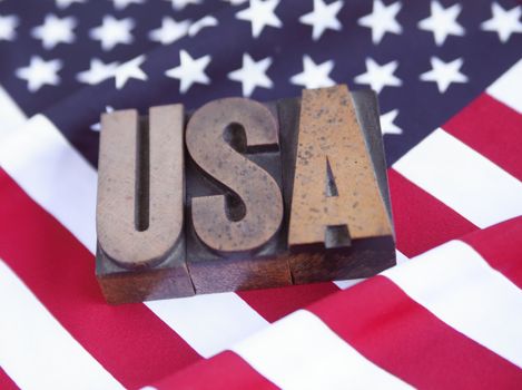 USA in wood type on an American flag