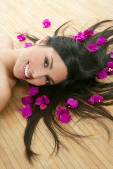 Beautiful indian woman portrait in a beauty spa with bougainvillea flowers