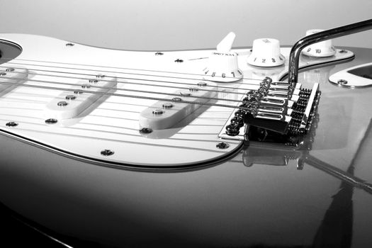 Black and white close up of neck of guitar