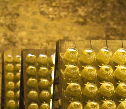 Closeup of bottles of wine aging in an old cellar