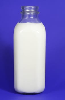 glass bottle filled with fresh milk