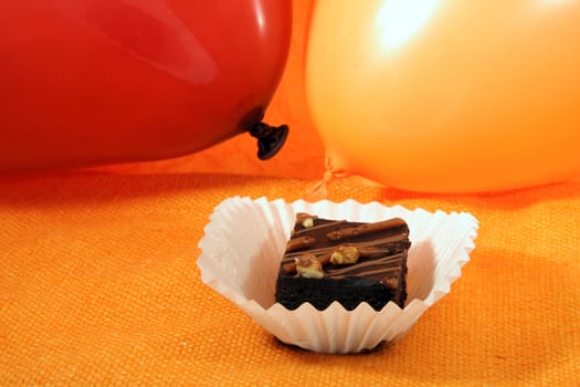 portion of brownie with balloon on background