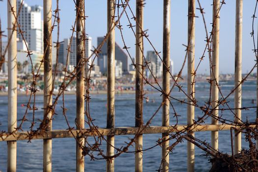 Tel Aviv city beach behind bars and iron tire