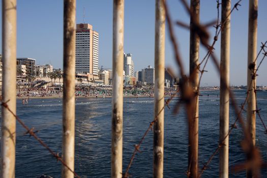 Tel Aviv beach behind bars of iron tire