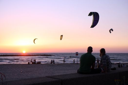 Romantic pair watch the sunset at beach