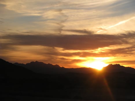 Arizona Desert Sunset captured with beautiful orange and blue clouds along with a airplane contrail. v1
