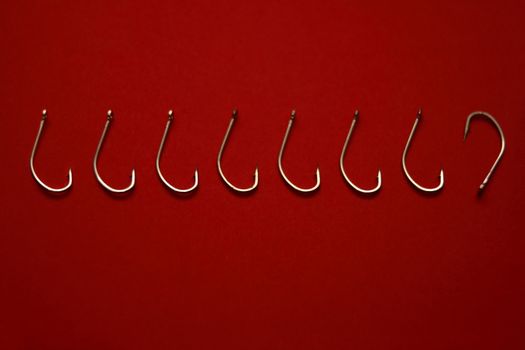 A set of fishing hooks in various conceptive situations.