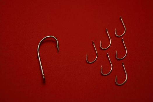 A set of fishing hooks in various conceptive situations.