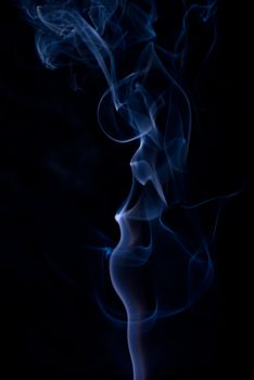 Colored smoke wisps on black background