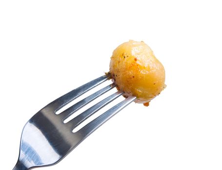 baked potatoes,roasted vegetables Close-up .fork with potatoes