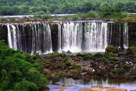 The Iguassu (or Iguazu) Falls is one of the largest masses of fresh water on the planet and divides, in South America, Brazil, Paraguay and Argentina. The waterfall system consists of 275 falls along 2.7 kilometres (1.67 miles) of the Iguazu River. Some of the individual falls are up to 82 metres (269 feet) in height, though the majority are about 64 metres (210 feet).