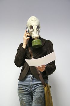 The woman in a gas mask speaks by phone