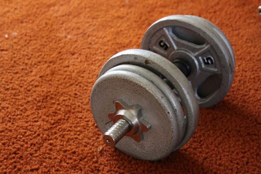 Close up of a Dumbell on a floor.