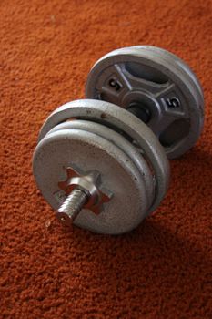 Close up of a Dumbell on a floor.