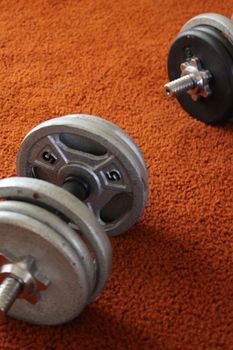 Close up of a Dumbell on a floor.