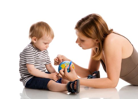 Happy mother holding globe with son isolated on white