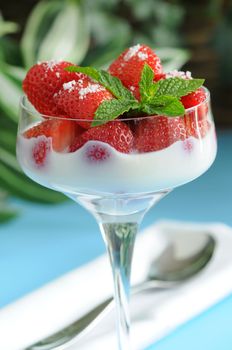 Fresh sliced strawberries and cream sprinkled with sugar.