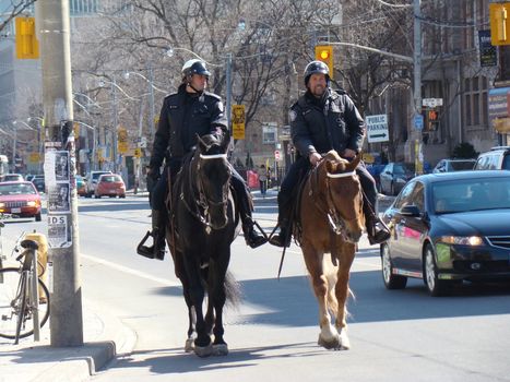 policemen riding horses on street