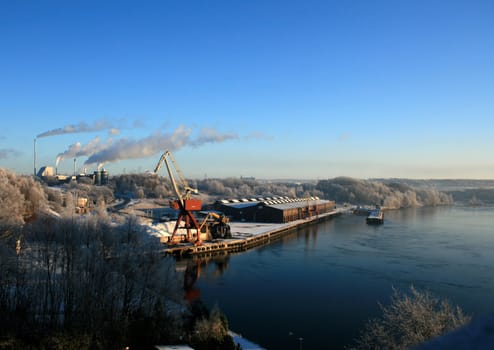 A quiet winter day at the harbour close to a factory