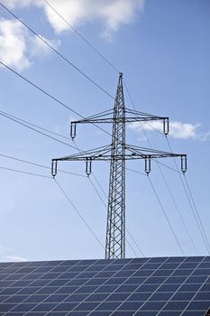 solar panels and a pylon on a sunny day