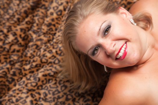 Beautiful Blonde Model Poses on Leopard Blanket.