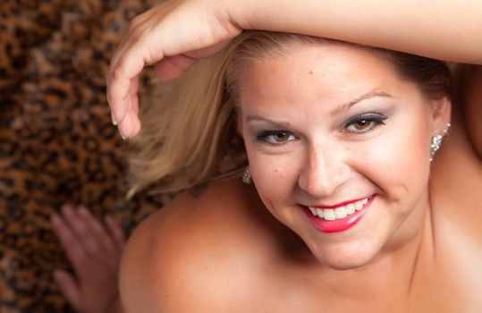 Beautiful Blonde Model Poses on Leopard Blanket.