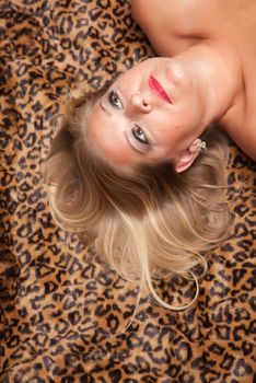 Beautiful Blonde Model Poses on Leopard Blanket.