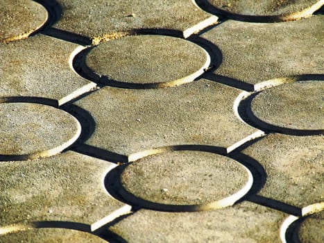 The photo shows a fragment of a pedestrian walkway, tiled