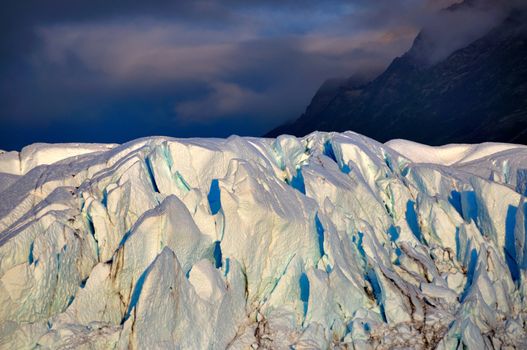 Matanuska glacier with dark clouds in the background.