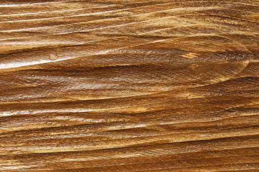 Relief wooden board surface is coated with varnish