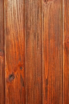 Parallel vertical wooden boards are covered with lacquer