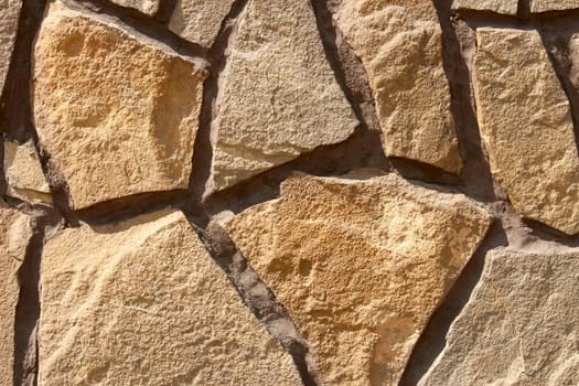 Fragment of multicolor ornamental stone wall covering 