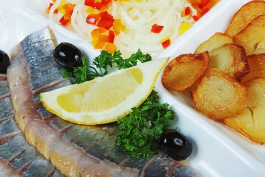 Fish with potatoes and spices on a plate