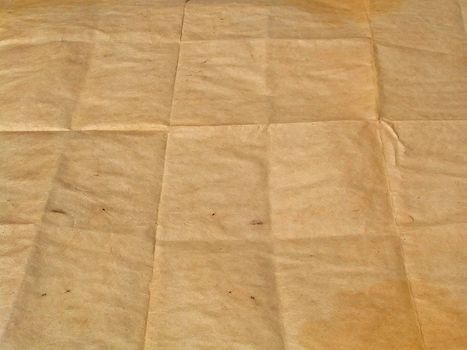 Piece of old brown paper represented in the long term which has been combined by squares.