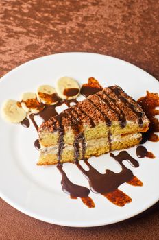 Dessert cakes with banana and coffee at table