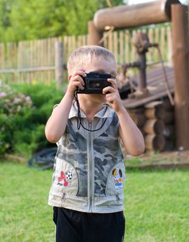 The boy photographs on a country site