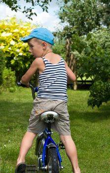 The child of outdoor goes for a drive on  bicycle