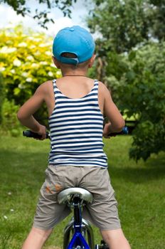 Child of the nature goes for drive on a bicycle