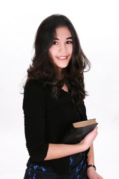 Teen girl holding Bible, smiling