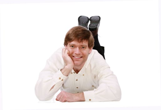 Handsome business man lying on floor relaxing, chin on hand