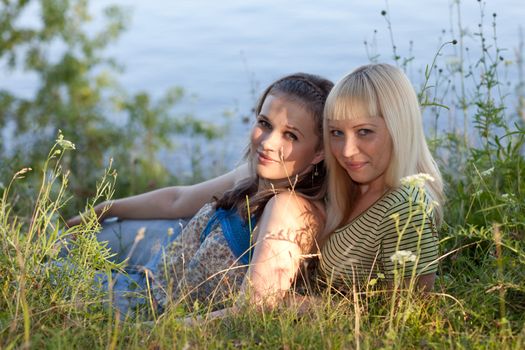 Two girlfriends on the nature. Beautiful girls