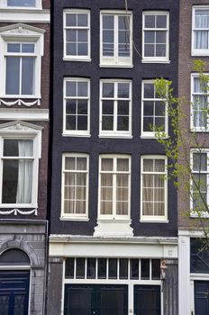 Facade of the Holland house with windows. Amsterdam. Fregment. Frontally
