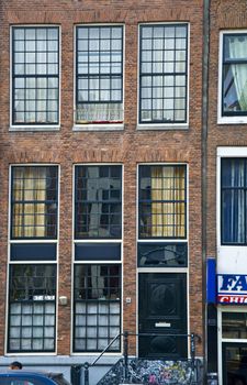 Facade of the Holland house with windows. Amsterdam. Fregment. Frontally