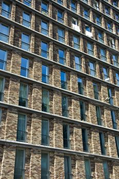 Fragment of the facade of the modern brick residential house with the same balcony. Detail.