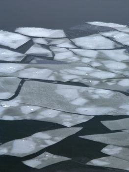 Large pieces of ice float down the Illinois River.