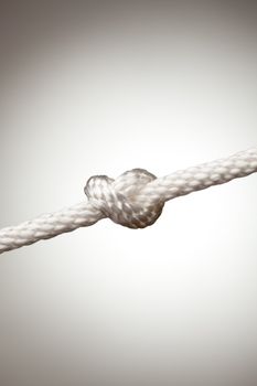 Nylon Rope Knot on a Spot Lit Background.