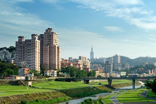 Here is a cityscape of apartment with blue sky.