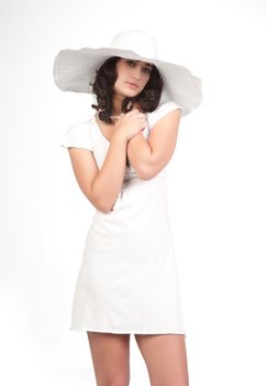 beautiful young fashion woman in white dress and hat